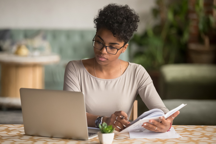 A financial advisor reading a book to prepare for the CFP exam.