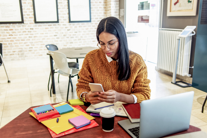 A woman calculating how much she will have to repay in student loans.