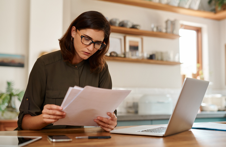 A woman reviewing documents for alimony in Florida.