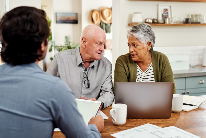 A couple meeting with an advisor to discuss a secure transaction for a purchase.