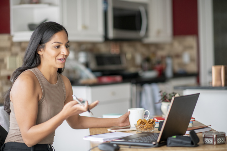 A financial advisor delivering a sales pitch to clients in a video conference.