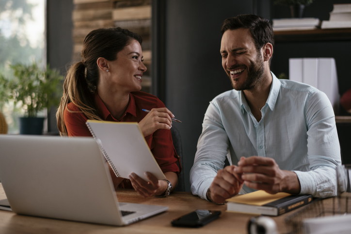 Financial advisors discussing client referral gift ideas.