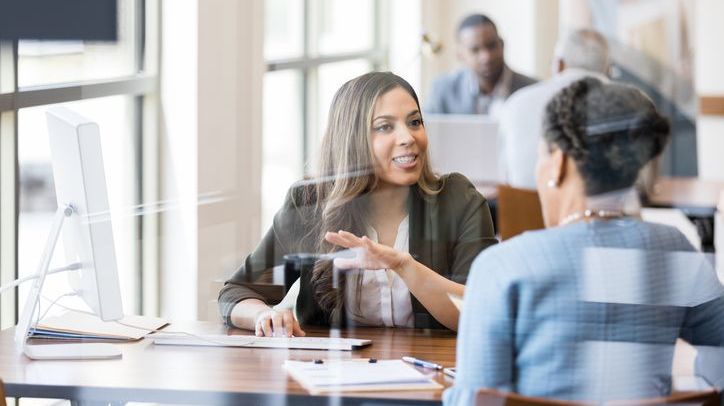 A credit union employee helps a member apply for a home loan.
