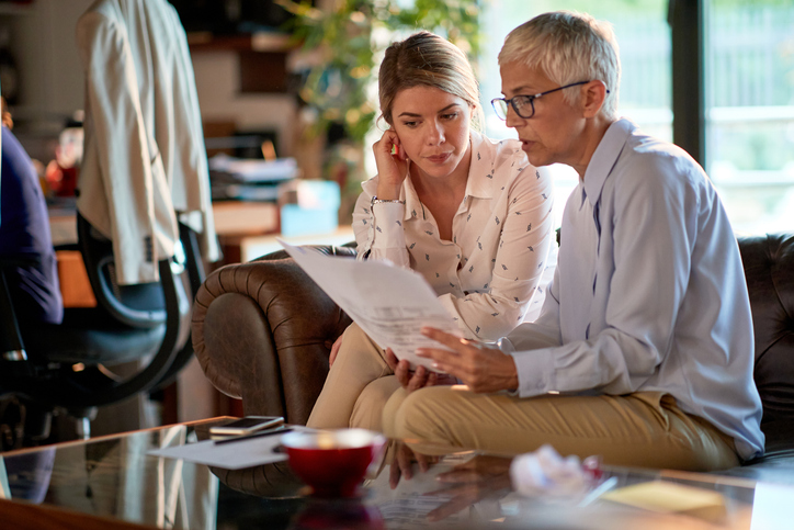 Two clients reviewing different types of advisor fees.