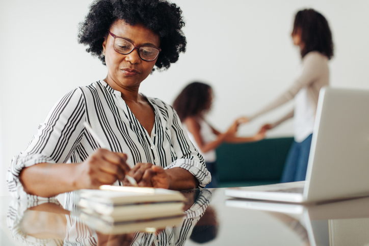 A 50-year-old using retirement benchmarks to adjust her retirement goals.