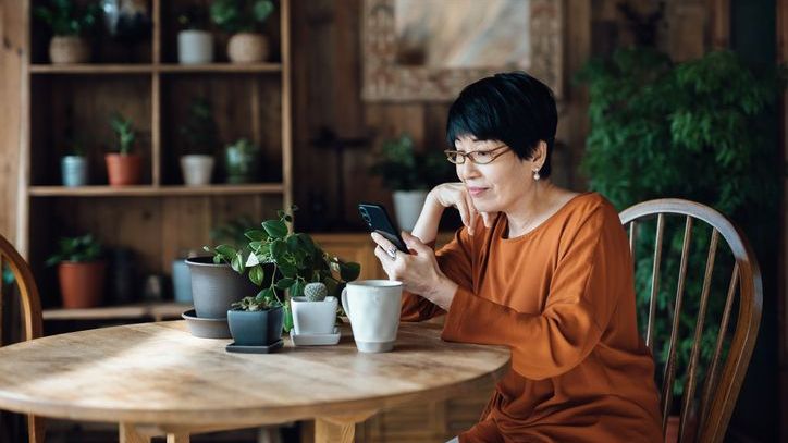 A woman contemplates purchasing fractional shares of an ETF.