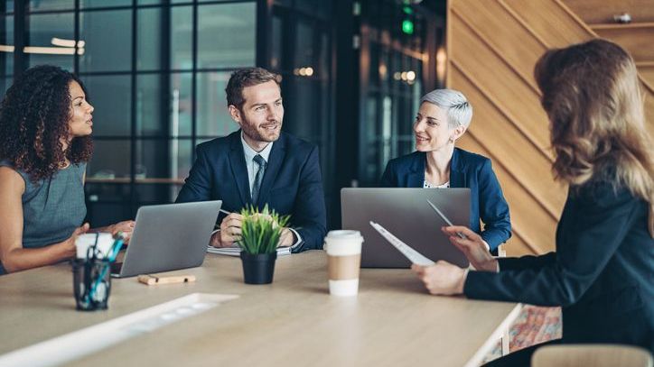 The principals of a financial advisory practice meet to discuss their ideal client avatar.