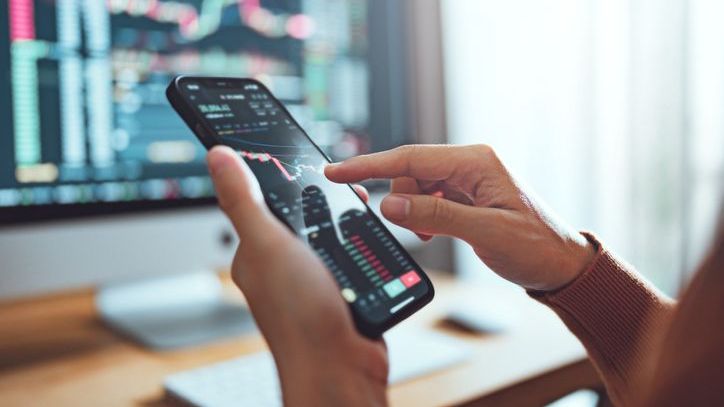 An investor looks at a stock's recent performance on her phone.