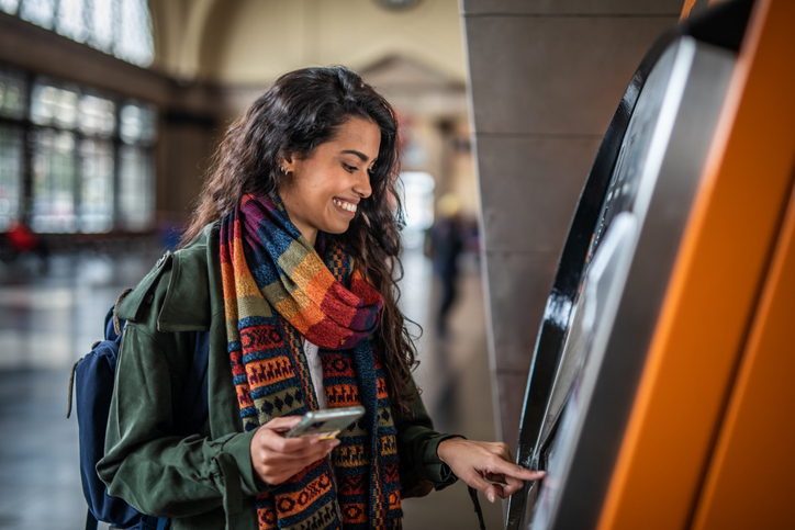 A regional bank customer takes money out of an ATM.