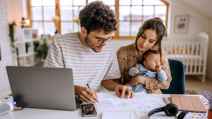 A couple goes over their finances in their home office/nursery.