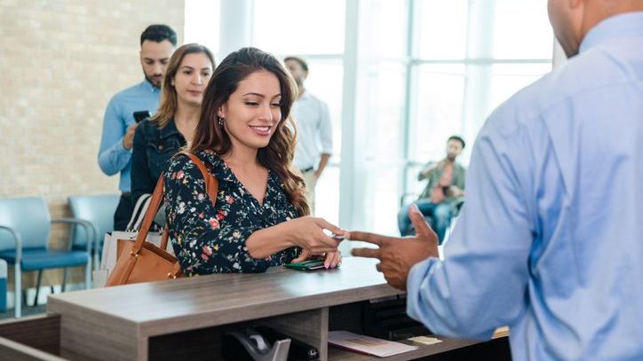 A woman speaks with a customer service representative at her credit union.