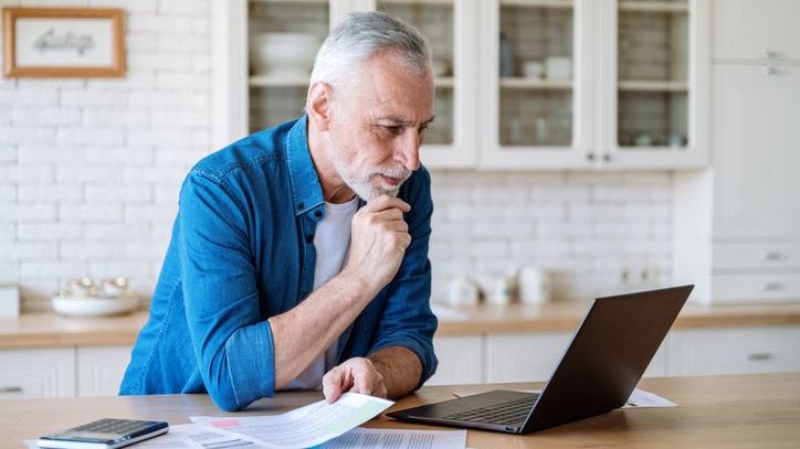 A man looks over his thrift savings plan account balance.