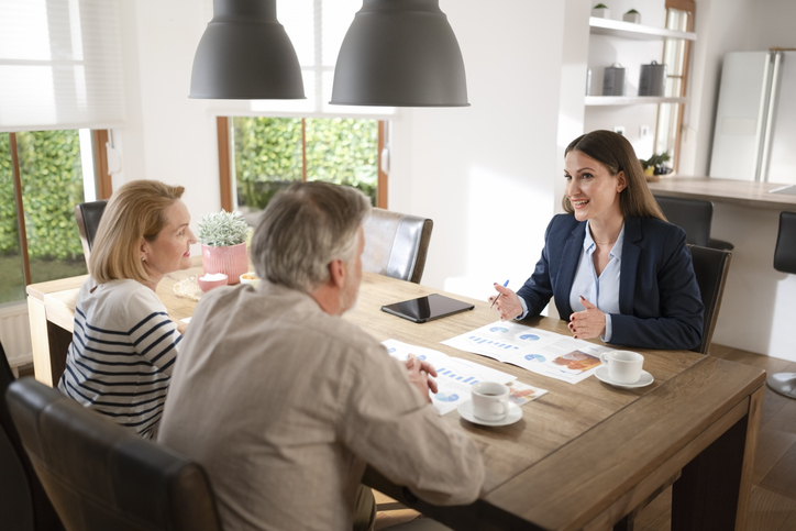 A senior couple meeting with a financial advisor to discuss their estate plan.
