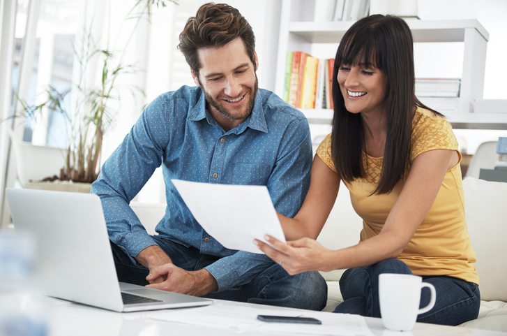 A couple researching tips to achieve long-term investment success.