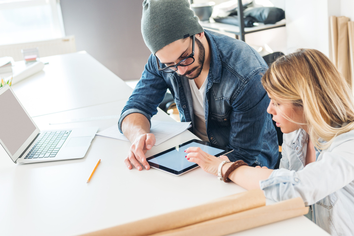 A couple creating a checklist of short- and long-term goals for their financial plan.