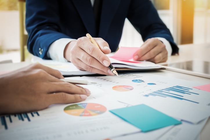 A financial advisor reviewing with a client how monopolistic competition is impacting investments.