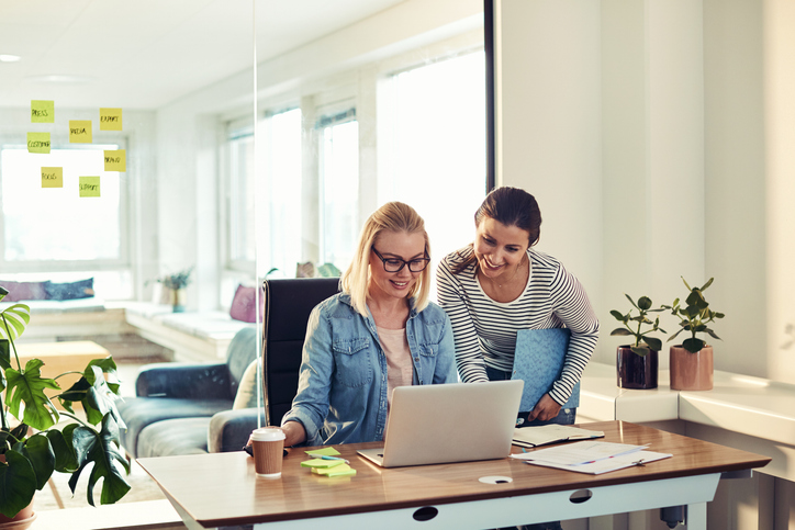 Two women researching probate laws in Florida.