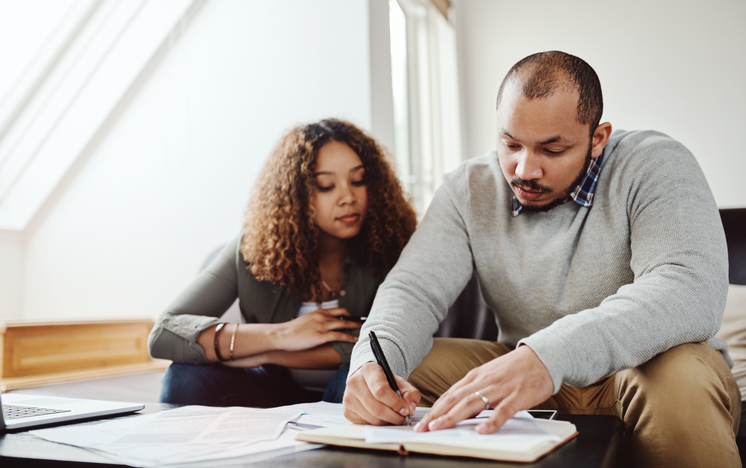 A couple creating a checklist for an estate plan that includes a power of attorney in Arkansas.