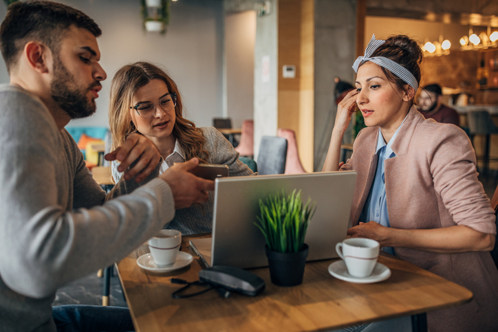 Clients meeting with a financial advisor at a cafe to discuss different types of powers of attorney in Arizona.