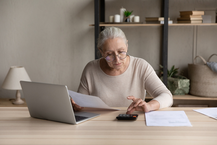 A woman calculating how much she will owe in estate taxes.