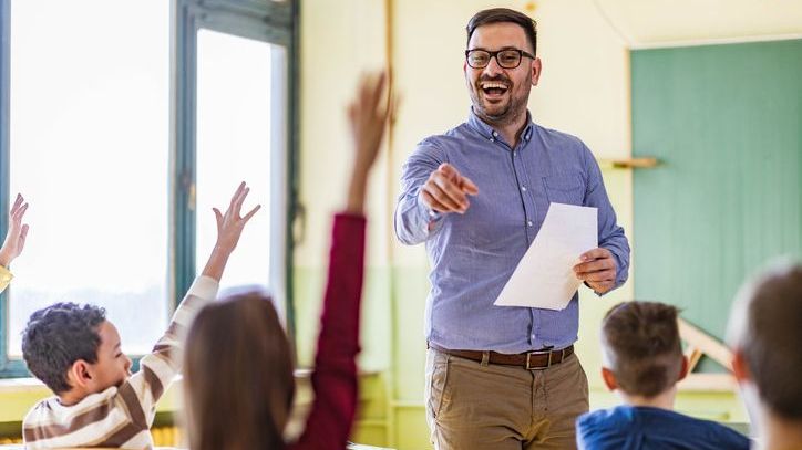A middle-aged teacher who has begun planning for his eventual retirement calls on a student during class.
