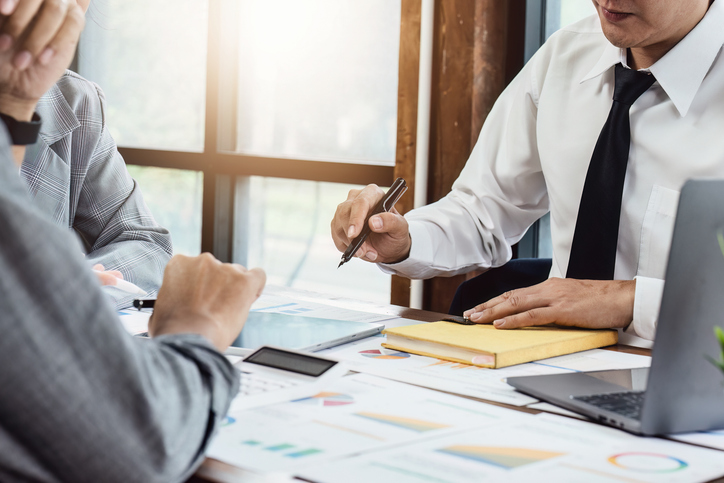 Financial advisors and web developer discussing RIA SEO strategy.