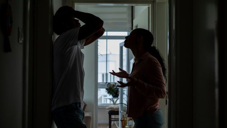 The silhouette of an arguing couple.