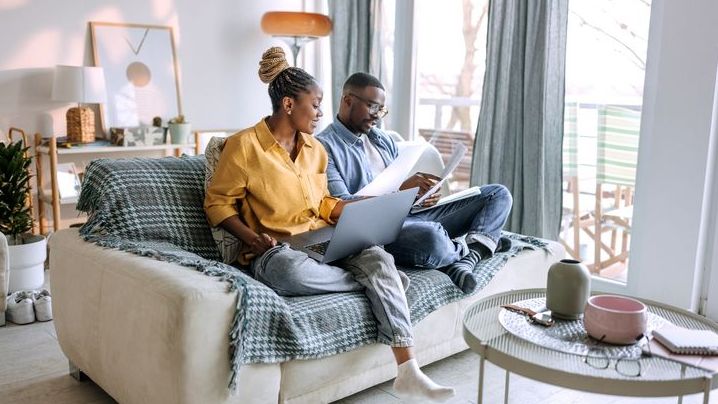 A couple looks over their capital gains and losses while working on their joint tax return.