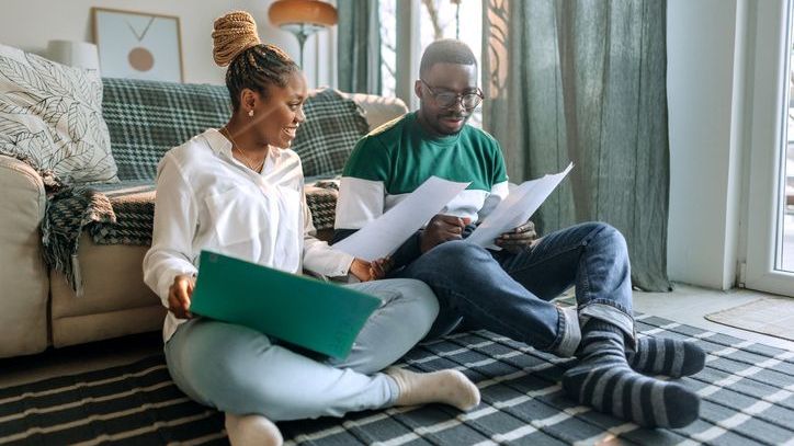 A married couple sits together and reviews their options for umbrella insurance and excess liability insurance.