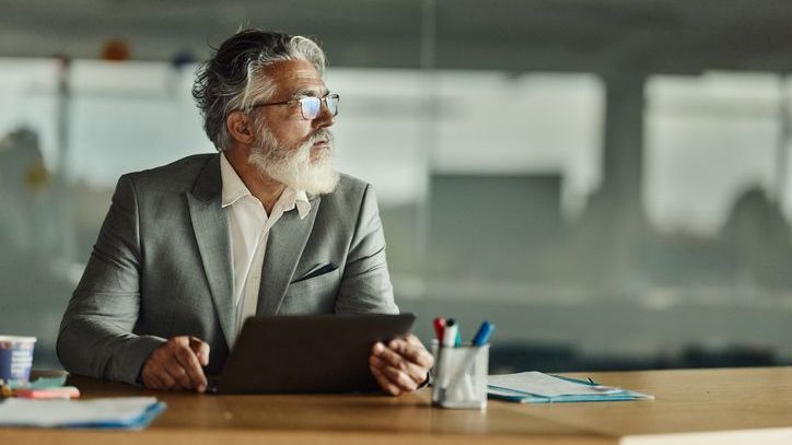 A man looks over his finances and wonders if he can afford to retire in five years.