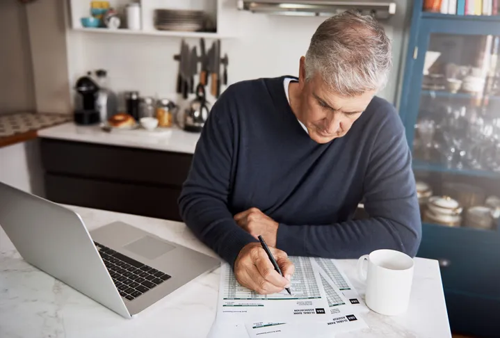 A man calculating how much he could earn by maxing out his Roth IRA.