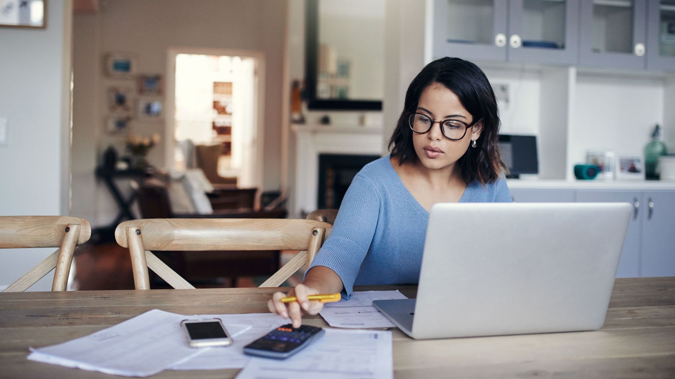 A woman looks over her portfolio of dividend stocks.