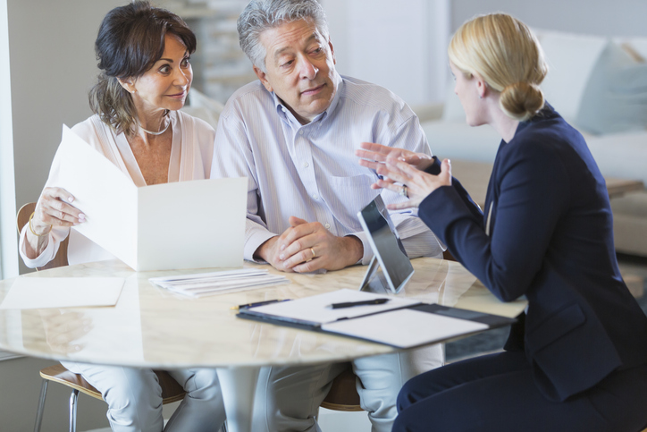 Ultra high net worth clients discussing investment opportunities with a private bank manager.