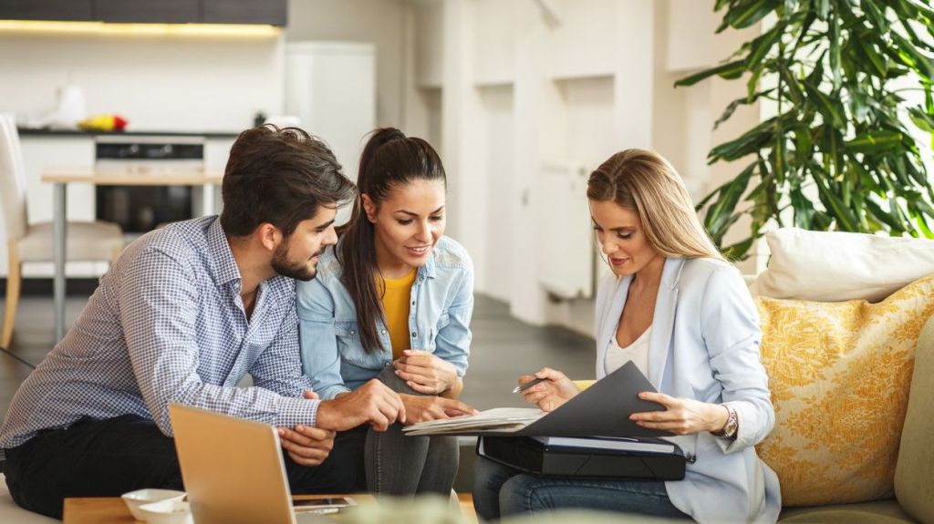 A financial advisor goes over a couple's financial goals with them.