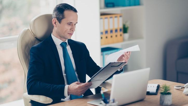 A financial advisor looks over a client's portfolio and considers how best to rebalance their holdings.