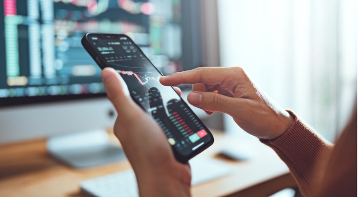 A woman looks up the price of a stock in her portfolio.