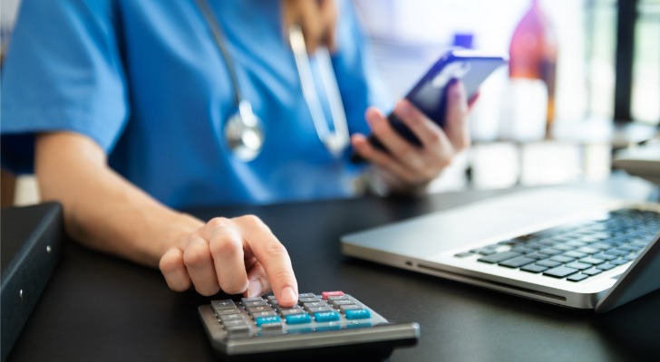 A medical professional making a calculation.