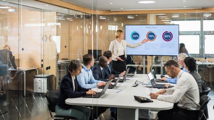 The financial manager of a company gives a presentation to the executives of a company.