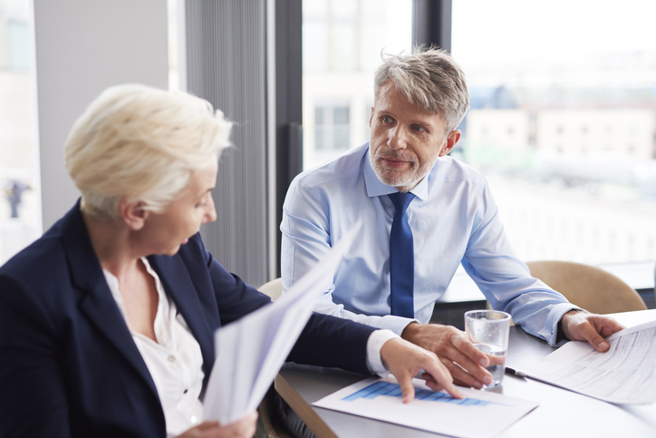 Two investors calculating a return on invested capital (ROIC).