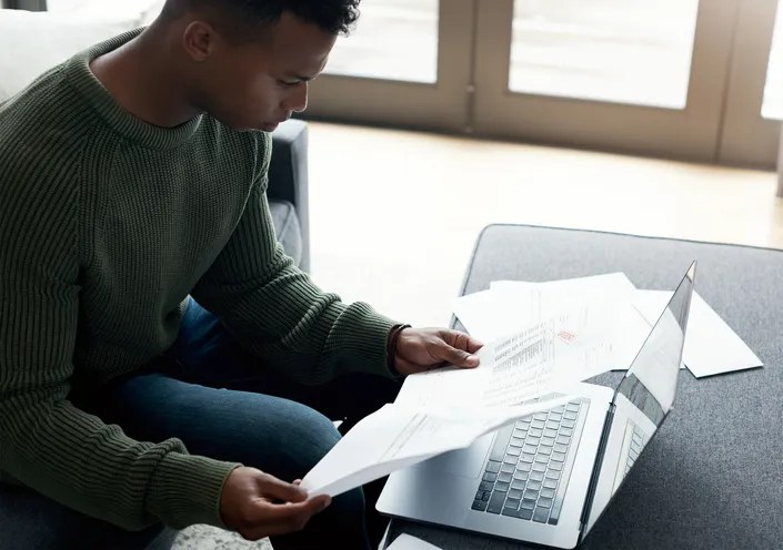 A man reviewing his investment portfolio and considering whether he should get both financial planning and investment management services.