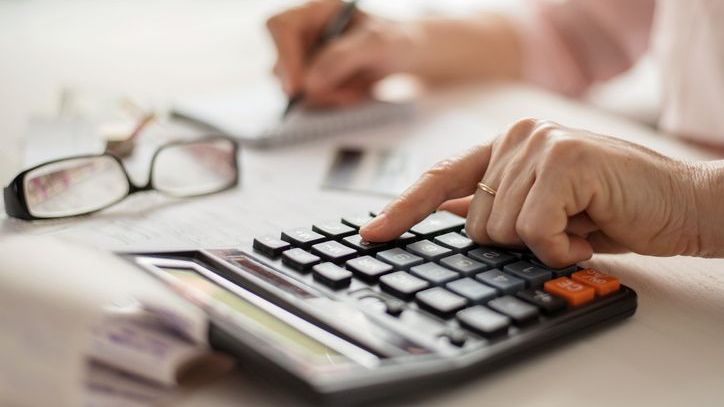 A retiree adds up her and her husband's monthly expenses.