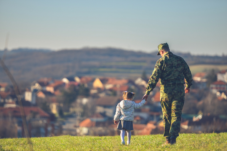 A father walks with his daughter, having navigated the military divorce retirement pension rules change.