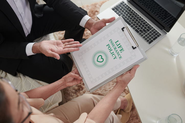 A woman reviewing how to create an immediate estate with a life insurance policy.