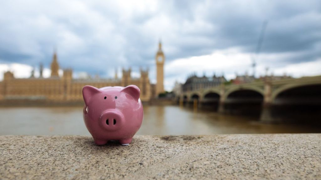A piggy bank representing a self-invested personal pension (SIPP) sits on the banks of the River Thames in London.