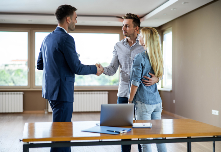 A couple closing on a real estate investment.