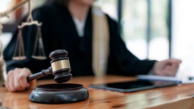 A probate judge hits her gavel during a hearing.