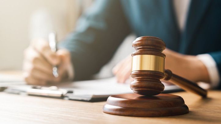 An estate attorney signs paperwork prior to filing documents for probate.