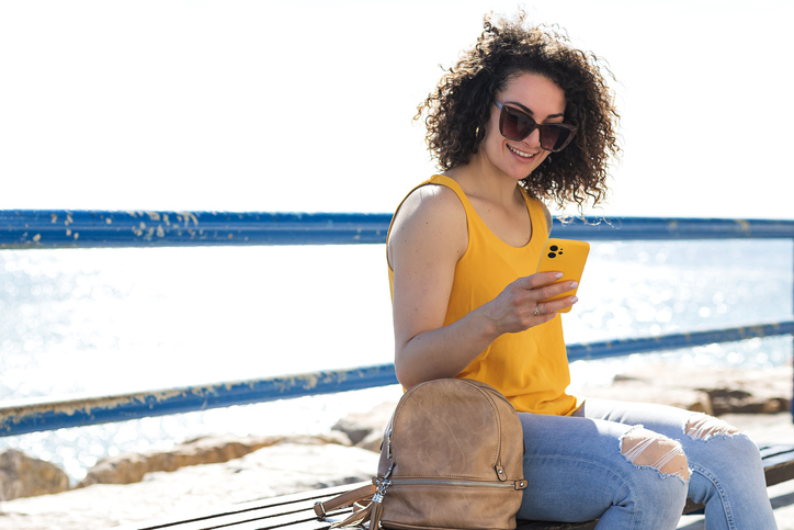A woman looking up investments on her phone.
