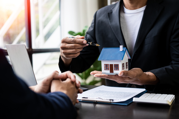 A financial advisor explaining the differences between equity REITs and mortgage REITs.