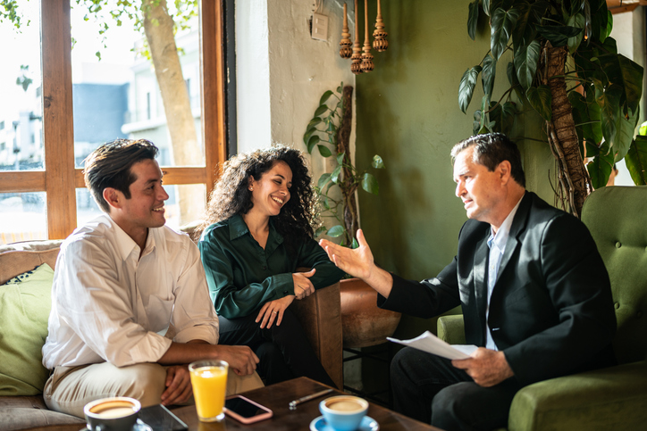 A couple sits down with their investment advisor to build a profitable portfolio.